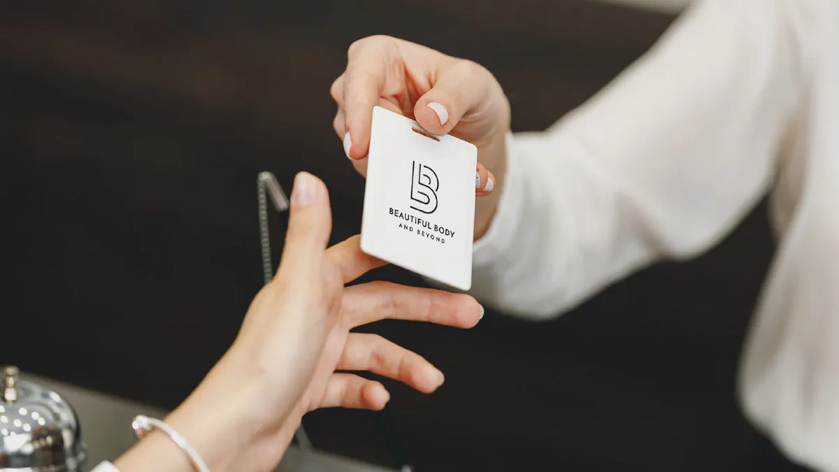 A Beautiful Body and Beyond membership card being handed to a client at the front desk