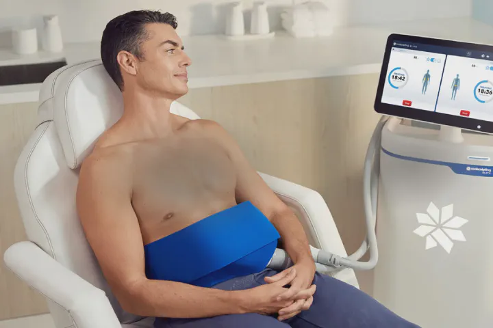 Patient relaxing during a CoolSculpting Elite treatment beside the Elite system at Beautiful Body and Beyond in Corona, CA