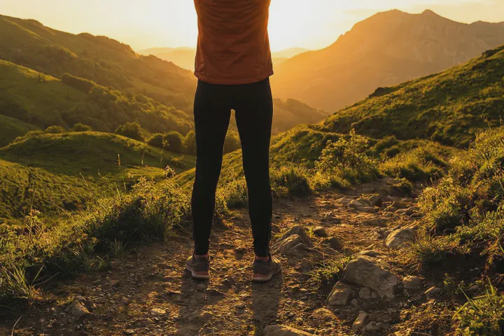 Person with arms raised at sunrise, representing renewed energy and vitality after testosterone replacement therapy