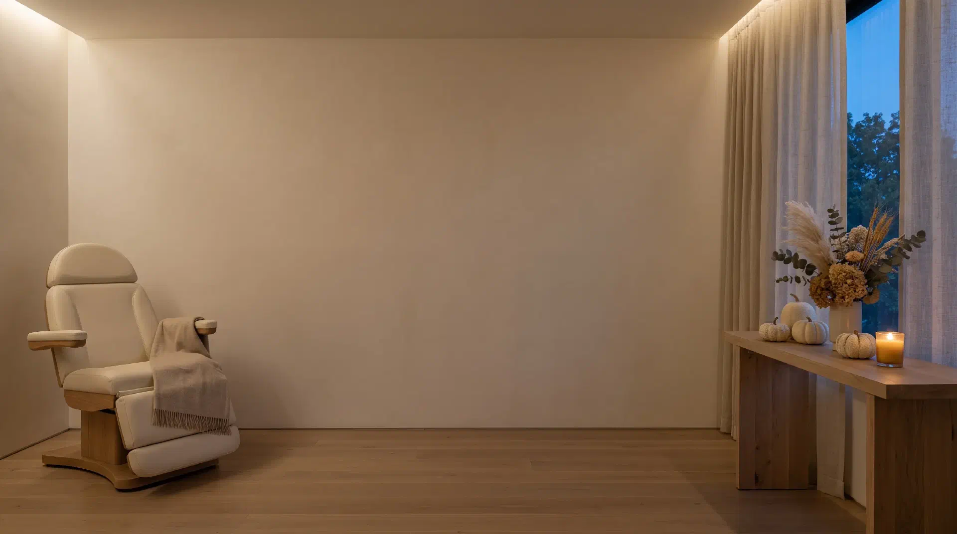 Candlelit treatment room with cream-white pumpkins at Beautiful Body and Beyond in Corona, CA, announcing the October 2026 specials